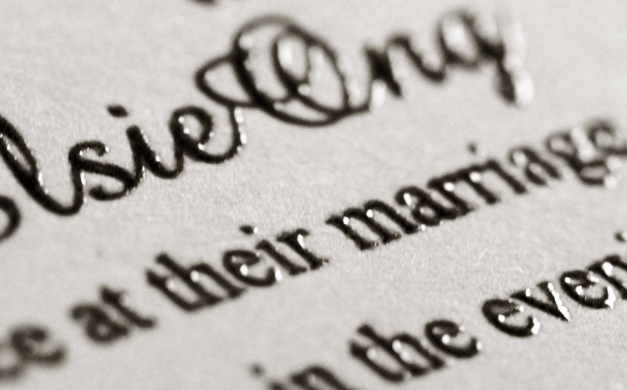 A close-up of a marriage invitation showing thermography printing, which can elevate luxury boxes in Singapore